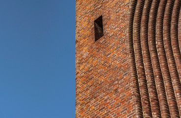 Part of the gothic cathedral with a window and a bend of the arch
