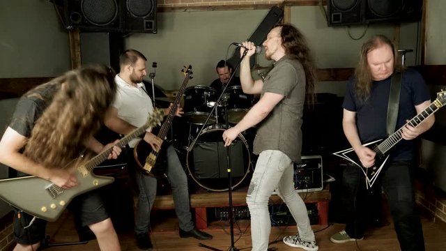 Musical metal band. Punk, heavy metal or rock group. Musicians playing music on stage. 4K