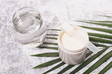 Collagen powder and a glass of water