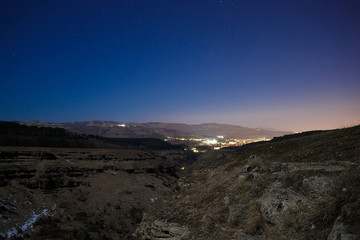 City in the night sky with stars.