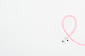 top view of stethoscope on white background with copy space, breast cancer concept