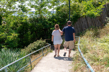 couple in casual walking in alley go to the beach in Arcachon Bay in France