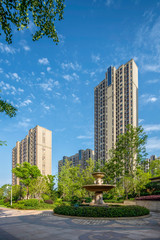 Fototapeta na wymiar Garden Landscape and Green Lawn in Gardens of Modern High-rise Residential Quarters