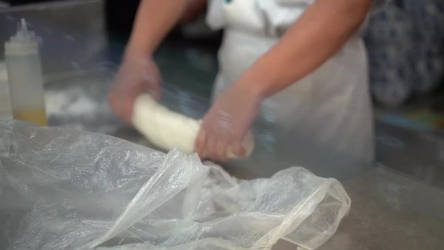 Making dough hand pulled noodles, repeatedly stretch dough to produce long thin strands.