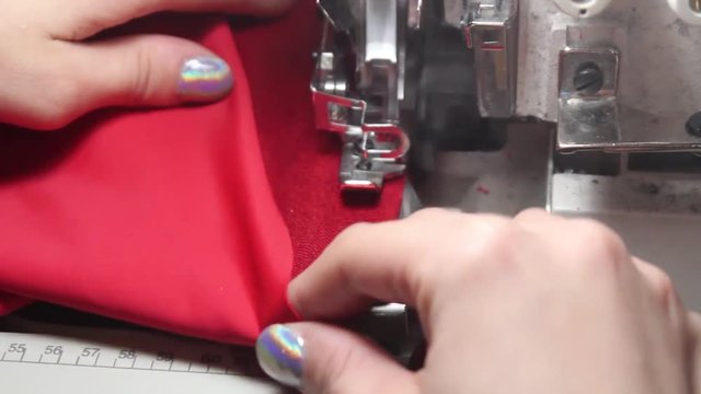 STICHING a piece of RED CLOTH with an automatic STICHER.