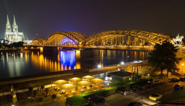 City Panorama at night, Cologne, Hohenzollern Bridge, Cathedral, Philharmonic Hall, Rhein, equestrian statue of Frederick William IV, glass roof and beer garden of the Hyatt Regency Hotel in front, Cologne, North Rhine-Westphalia, Germany, Europe