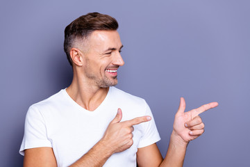 Close up photo amazing he him his middle age funny macho perfect appearance hand arm index finger direct empty space sincere cheerful charming wear casual white t-shirt isolated grey background