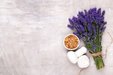 Grooming products and fresh lavender bouquet on white wooden table background.