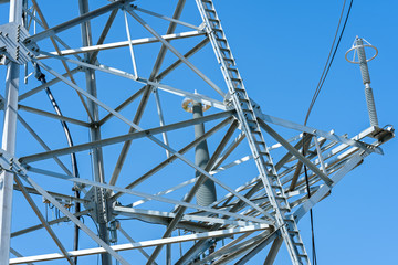 high voltage power line tower sky closeup