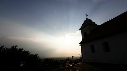 TIME LAPSE - a small church in the shadow with a sunset - Powered by Adobe