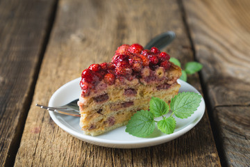 A piece of homemade cake with fresh strawberries