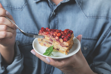 A piece of homemade cake with fresh strawberries