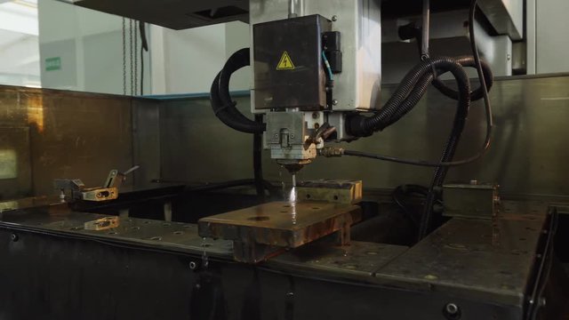 EDM machine, manufacturing process shapes metal by creating sparks