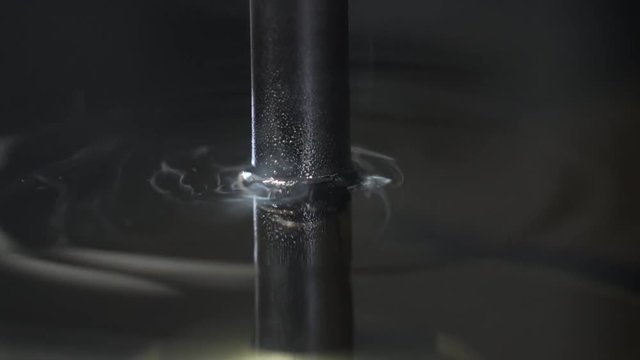 Close up sinker EDM manufacturing process shapes metal