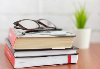 stack of books and glasses on the table,fiction for reading