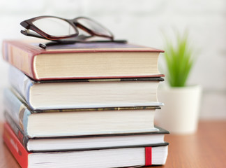 stack of books and glasses on the table,fiction for reading