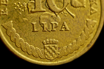 Coin ten Croatian lipa macro isolated on black background. Detail of metallic money close up. money of european country croatia