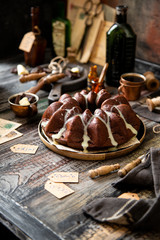 Delicious homemade chocolate bundt cake on wooden plate stands on rustic table