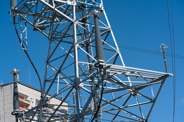 high voltage power line tower sky closeup