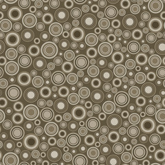 Seamless pattern. It consists of geometric elements having a round shape, different color and size, located on brown background. Useful as design element for texture and artistic compositions.