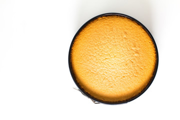Baking food concept fresh baked homemade sponge cake in cake pan on white background with copy space