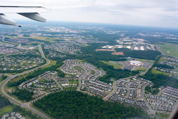 Aerial View of Residence Houses taken from Flying Airplane on Blur Background