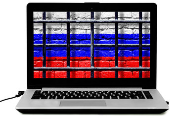 Personal laptop with prison bars and Russian flag painted on a brick wall on the screen isoalted on the white background. Law of disconnecting Russian Internet from the world wide web comcept