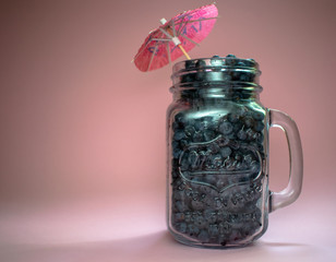 Jar of blueberries on a pink background 4