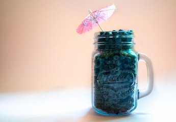 Jar of blueberries on a pink background 1