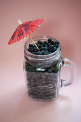 Jar of blueberries on a pink background 5