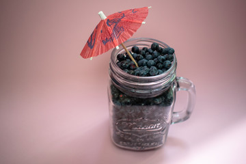 Jar of blueberries on a pink background 6