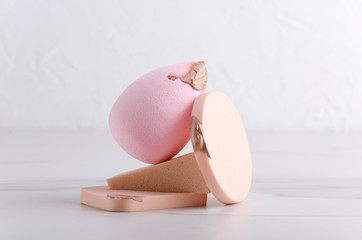 Cosmetic sponges and smear of concealer on it on.Closeup of stack of cosmetic sponges
