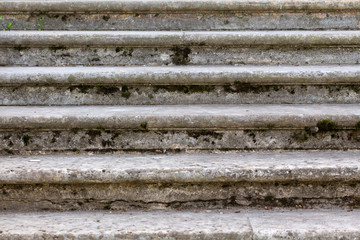Fototapeta premium Old open outdoor stone staircase. Stone steps of the old stairs with traces of weathering