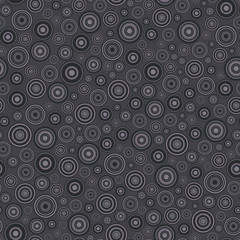 Seamless pattern. Disjoint geometric elements of a round shape chaotically located on dark purple background.
