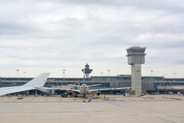 Close up of Wing of Airplane on Airplane waiting for Maintenance at the Airport Background