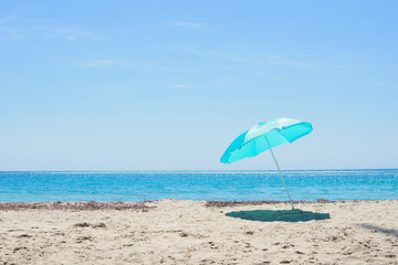 Sun umbrella on the sandy beach.