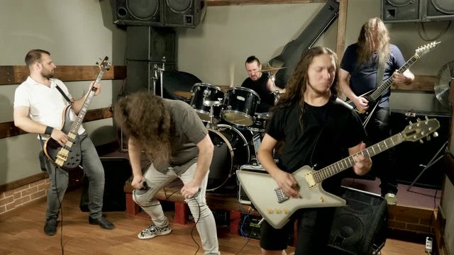 Musical metal band. Punk, heavy metal or rock group. Musicians playing music on stage. 4K
