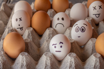 Eggs with funny faces drawn. Concept of diversity and moods.