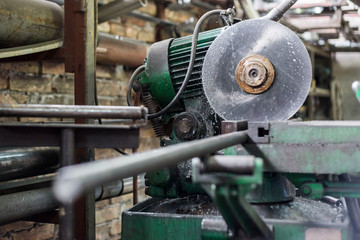 Cutting the metal pipes on a circular saw