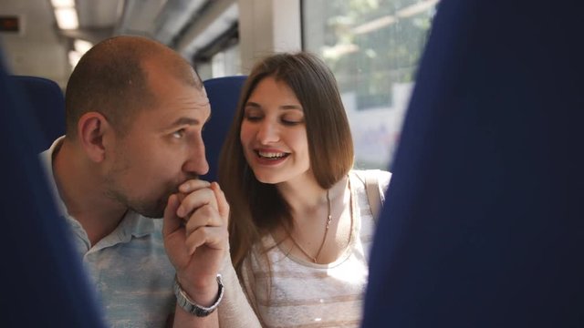 Couple of travelers sitting in a chair in the elektro train, and consider in the scenery.