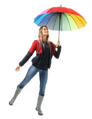 Beautiful young woman with umbrella on white background