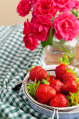 Heap of fresh strawberries in ceramic bowl on rustic background