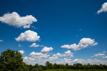 White, fluffy clouds in blue sky. Background from clouds.