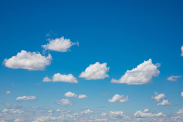 White, fluffy clouds in blue sky. Background from clouds.