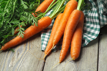 Close up of fresh carrot on rustic wooden background