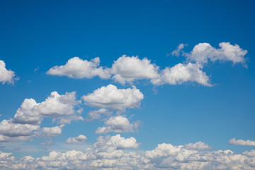 White, fluffy clouds in blue sky. Background from clouds.