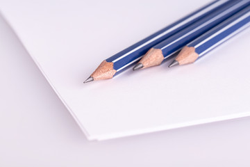 the three  pencil on white paper
