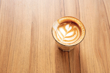 Hot latte on a wooden table