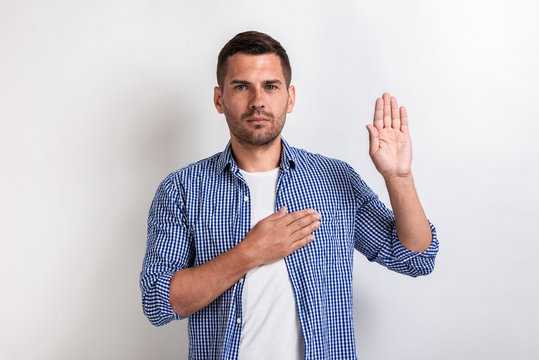 Serious man makes a gesture swear. Concept gesture.- Image