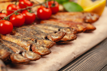 fish grill dish baked whole grilled on a plate with vegetables and lemon